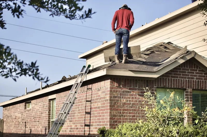 Professional roofer working on a residential roof in Worthington